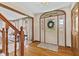 Elegant foyer with hardwood floors, a staircase, and a decorative front door with sidelights at 5341 W Stonehaven Ln, New Palestine, IN 46163