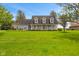 Charming gray two-story home with a welcoming front porch, well-manicured lawn, and landscaped garden at 5341 W Stonehaven Ln, New Palestine, IN 46163