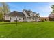 Charming two-story home with a welcoming front porch, well-manicured lawn, and landscaped garden at 5341 W Stonehaven Ln, New Palestine, IN 46163