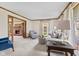 Cozy living room with plush seating, natural light, and a fireplace, creating a warm and inviting atmosphere at 5341 W Stonehaven Ln, New Palestine, IN 46163