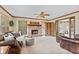 Comfortable living room with brick fireplace, ceiling fan and traditional furniture at 5341 W Stonehaven Ln, New Palestine, IN 46163