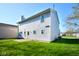 Exterior of home showcasing a backyard with green grass and vinyl siding at 5424 Milhouse Rd, Indianapolis, IN 46221