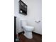Close-up of a well-maintained toilet in a bathroom with wood-look vinyl flooring at 5424 Milhouse Rd, Indianapolis, IN 46221