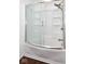 A bathtub and shower combo behind a glass door at 5424 Milhouse Rd, Indianapolis, IN 46221