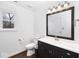 This bathroom has a dark vanity, and dark wood floor at 5424 Milhouse Rd, Indianapolis, IN 46221