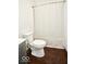 Bathroom features a toilet, shower with curtain, and hardwood floors at 5424 Milhouse Rd, Indianapolis, IN 46221
