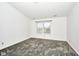 This bedroom features gray carpeting, neutral walls, and a window at 5424 Milhouse Rd, Indianapolis, IN 46221