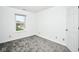 A bedroom featuring a window and neutral carpeting at 5424 Milhouse Rd, Indianapolis, IN 46221