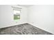 This bedroom has neutral walls and carpeting and a view to the street at 5424 Milhouse Rd, Indianapolis, IN 46221