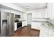 Well-lit kitchen with stainless steel appliances, granite countertops, and ample cabinet space at 5424 Milhouse Rd, Indianapolis, IN 46221