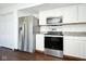 Bright kitchen featuring stainless steel appliances including a refrigerator, microwave, and oven at 5424 Milhouse Rd, Indianapolis, IN 46221
