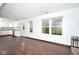 Bright living room featuring hardwood floors, neutral walls, and large windows offering natural light at 5424 Milhouse Rd, Indianapolis, IN 46221