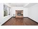 Cozy living room featuring a brick fireplace, hardwood floors, and large windows at 5424 Milhouse Rd, Indianapolis, IN 46221