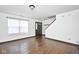 Inviting foyer with hardwood floors, staircase, and a bright window at 5424 Milhouse Rd, Indianapolis, IN 46221