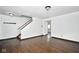 Bright living room with hardwood floors, a staircase, and neutral colored walls at 5424 Milhouse Rd, Indianapolis, IN 46221