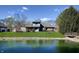 A backyard view with lush greenery, a charming bridge, and tranquil pond create a private oasis at 5441 Red Hawk Ln, Greenwood, IN 46142