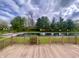 Backyard deck view of a scenic pond surrounded by trees at 5441 Red Hawk Ln, Greenwood, IN 46142