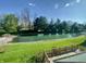 Scenic backyard view of a pond and surrounding trees at 5441 Red Hawk Ln, Greenwood, IN 46142