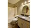 Full bathroom with a shower, toilet, vanity and sink with a circular mirror above it at 5441 Red Hawk Ln, Greenwood, IN 46142