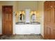 Bathroom with double sink vanity, decorative mirrors and lighting fixtures at 5441 Red Hawk Ln, Greenwood, IN 46142