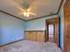 Blue bedroom with a ceiling fan, neutral carpet, built-in storage and hardwood floors at 5441 Red Hawk Ln, Greenwood, IN 46142