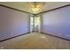 Bedroom with a ceiling fan, neutral carpet, natural light, and painted lavender walls at 5441 Red Hawk Ln, Greenwood, IN 46142