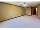 Large carpeted bedroom with brown trim around the ceiling and doorway at 5441 Red Hawk Ln, Greenwood, IN 46142