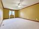 A spacious bedroom features neutral carpet, trim, and a ceiling fan at 5441 Red Hawk Ln, Greenwood, IN 46142