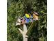 Multi-tiered colorful birdhouse adds charm to the outdoor living space at 5441 Red Hawk Ln, Greenwood, IN 46142