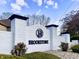 Brookstone community entrance with a white brick wall, black trim and a logo featuring the letter 'B' at 5441 Red Hawk Ln, Greenwood, IN 46142
