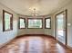 Bright dining area features hardwood floors, trim, and multiple windows letting in tons of natural light at 5441 Red Hawk Ln, Greenwood, IN 46142