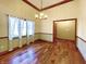 Dining room features hardwood floors, chandelier, and large windows at 5441 Red Hawk Ln, Greenwood, IN 46142