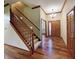 Inviting foyer with wood floors, staircase, chandelier, and paneled wood doors at 5441 Red Hawk Ln, Greenwood, IN 46142