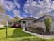 Beautifully landscaped front yard with lush lawn and stone walkway to the covered front door at 5441 Red Hawk Ln, Greenwood, IN 46142