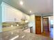 Updated kitchen with granite countertops, tile backsplash, and stainless steel sink at 5441 Red Hawk Ln, Greenwood, IN 46142