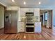 Modern kitchen with stainless steel appliances, granite countertops, and hardwood floors at 5441 Red Hawk Ln, Greenwood, IN 46142