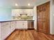 Kitchen with stainless steel dishwasher, tile backsplash, and white cabinets at 5441 Red Hawk Ln, Greenwood, IN 46142