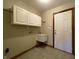 Laundry room with storage cabinets, a sink, and linoleum flooring at 5441 Red Hawk Ln, Greenwood, IN 46142