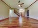 Spacious living room featuring hardwood floors, a staircase, and natural light at 5441 Red Hawk Ln, Greenwood, IN 46142