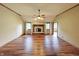 Bright living room with a cozy fireplace, hardwood floors, and large windows at 5441 Red Hawk Ln, Greenwood, IN 46142