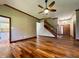 Open-concept living room with stairway and view of the front door and kitchen at 5441 Red Hawk Ln, Greenwood, IN 46142