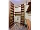 Large walk-in closet with custom shelving and hanging rods for optimal organization at 5441 Red Hawk Ln, Greenwood, IN 46142