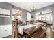 Inviting dining room boasts hardwood floors, stylish chandelier, and easy access to the kitchen and living spaces at 5442 Hibben Ave, Indianapolis, IN 46219