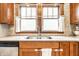 A close up of the kitchen sink with granite countertops and stainless steel appliances at 5442 Hibben Ave, Indianapolis, IN 46219