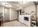 Laundry room with white washer and dryer, storage, and wooden flooring at 5442 Hibben Ave, Indianapolis, IN 46219