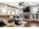 Cozy living room with a brick fireplace, large TV, and comfortable seating at 5442 Hibben Ave, Indianapolis, IN 46219
