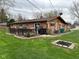 Spacious backyard with a wooden deck, lush lawn, and a charming brick home at 5626 Hammon Dr, Brownsburg, IN 46112