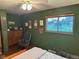 Green bedroom with a wooden dresser, decorations, and a rocking chair at 5626 Hammon Dr, Brownsburg, IN 46112