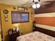 Comfortable bedroom with colorful wall art, a ceiling fan, and natural light from the window at 5626 Hammon Dr, Brownsburg, IN 46112