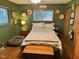 Cozy bedroom with dark green walls, wooden furniture, and a comfortable dog bed at 5626 Hammon Dr, Brownsburg, IN 46112